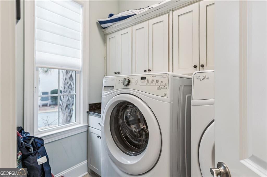 172 Turtle Track Lane, Unit OCEAN Jekyll Island, GA 31527 - Photo 29 of 51 a utility room with dryer and washer