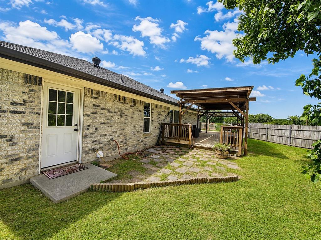404 Old Mansfield Road Keene, TX 76059 - Photo 26 of 33 View of deck and door going into the garage from the backyard