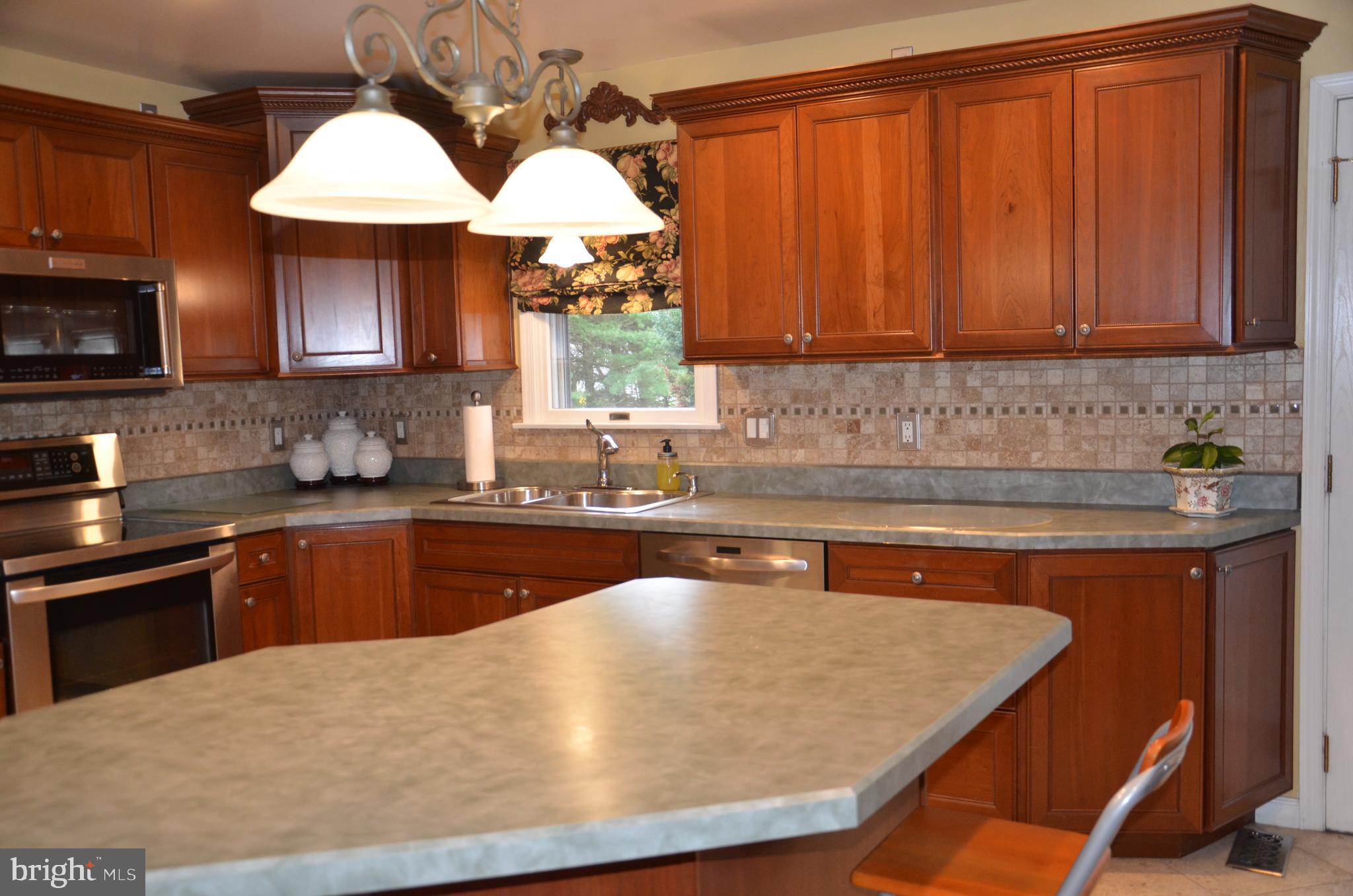 19704 Trunk Road White Hall, MD 21161 - Photo 15 of 59 Pendant lighting over the breakfast bar/island
