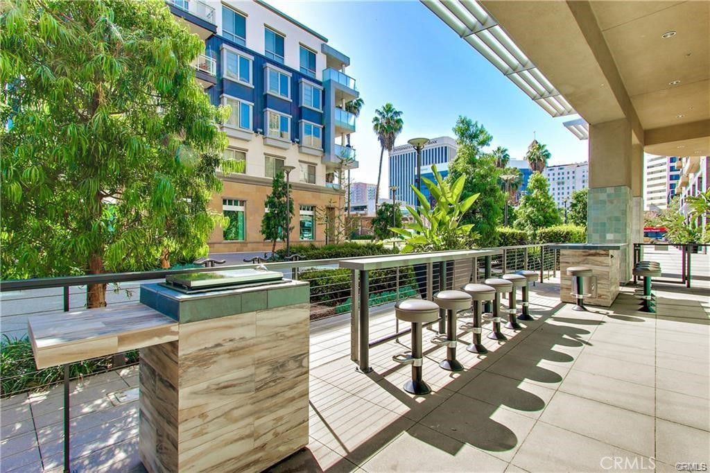 133 The Promenade North, Unit 402 Long Beach, CA 90802 - Photo 20 of 26 a view of a patio with couches table and chairs and potted plants