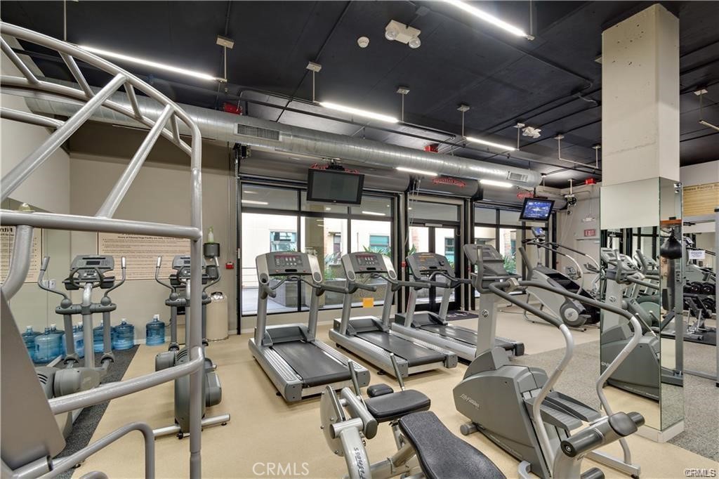 133 The Promenade North, Unit 402 Long Beach, CA 90802 - Photo 22 of 26 a view of a room with lots of chairs and a chandelier