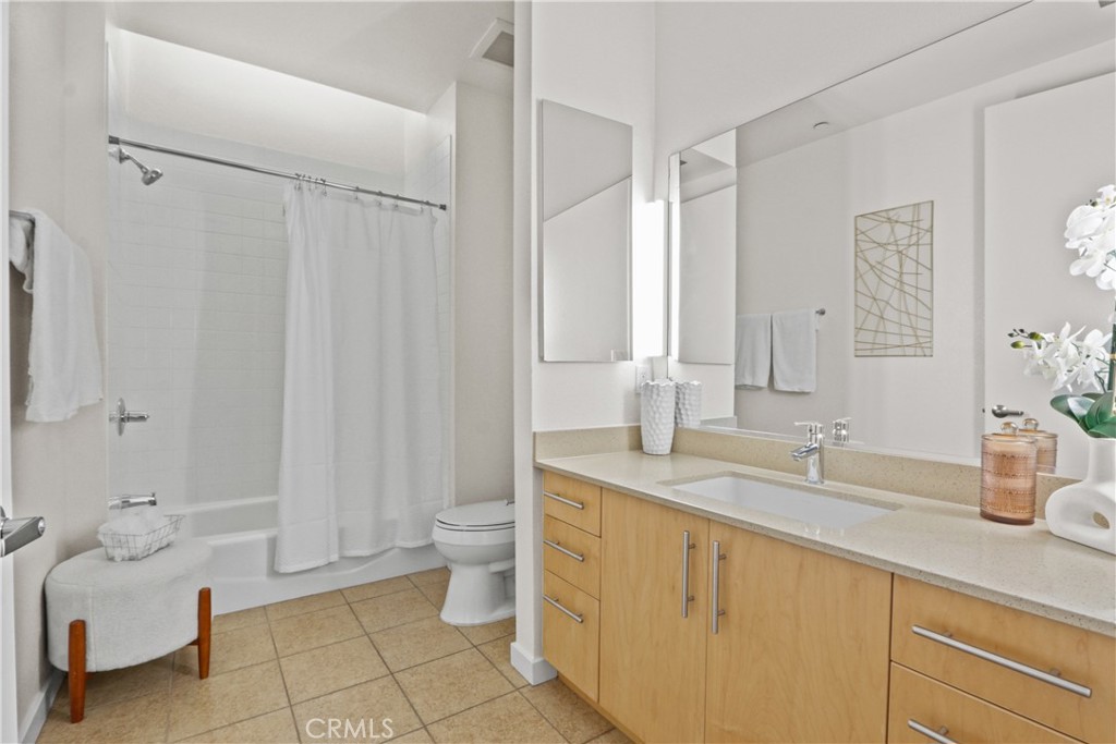 133 The Promenade North, Unit 402 Long Beach, CA 90802 - Photo 4 of 26 a spacious bathroom with a double vanity sink toilet and shower
