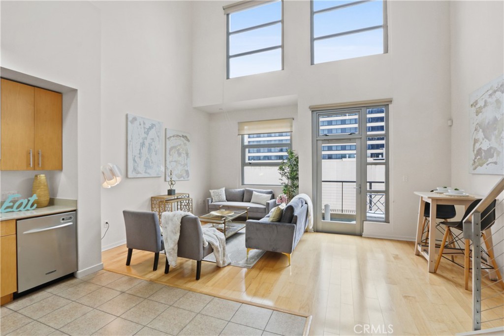 133 The Promenade North, Unit 402 Long Beach, CA 90802 - Photo 6 of 26 a living room with furniture a flat screen tv and windows