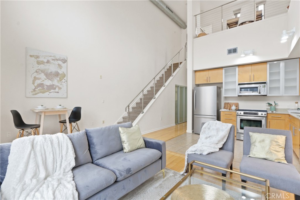 133 The Promenade North, Unit 402 Long Beach, CA 90802 - Photo 7 of 26 a living room with furniture and a view of kitchen