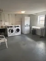 a utility room with cabinets and window