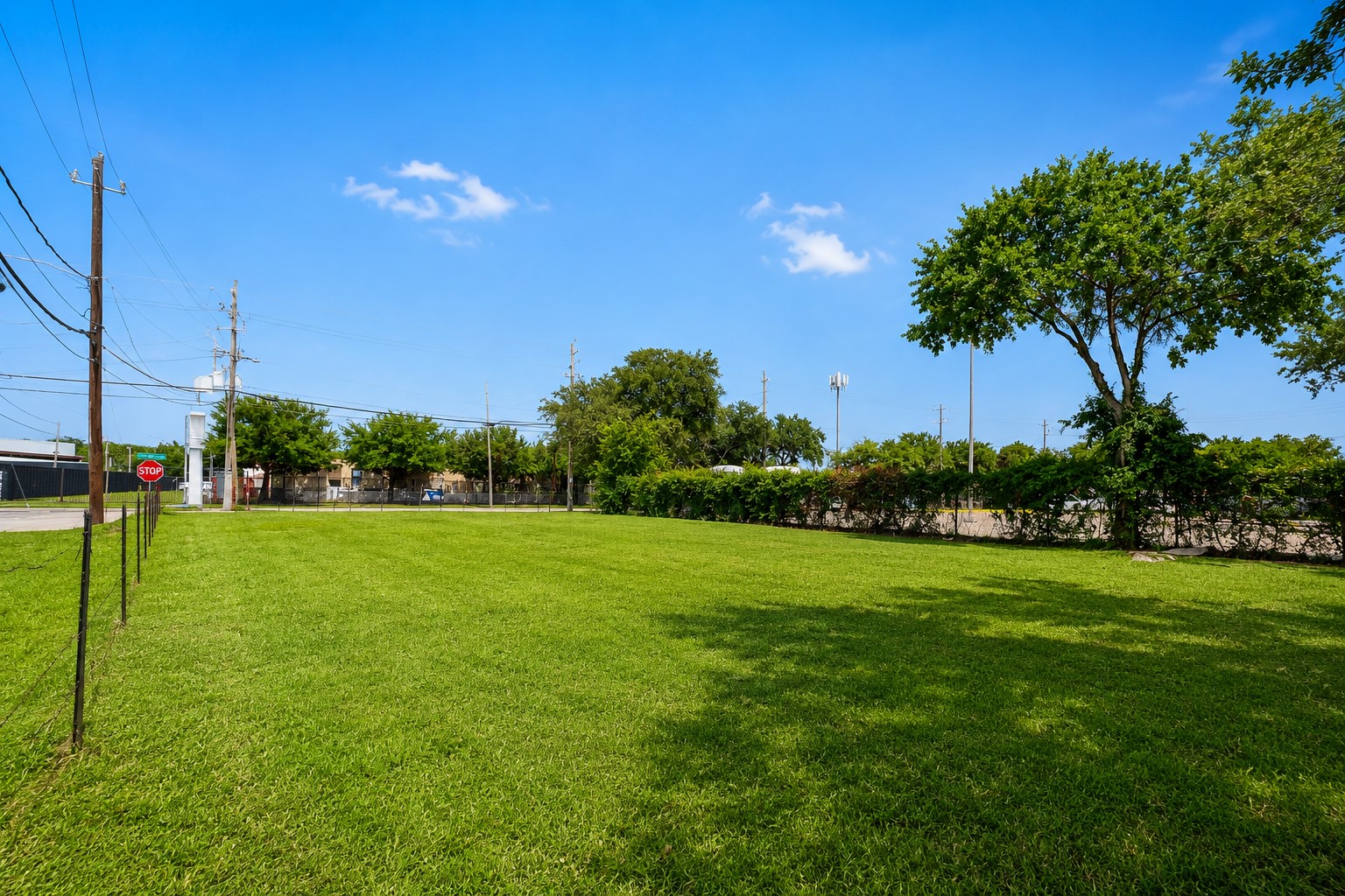 2002 Telephone Road Houston, TX 77023 - Photo 6 of 8 a view of a grassy field with trees