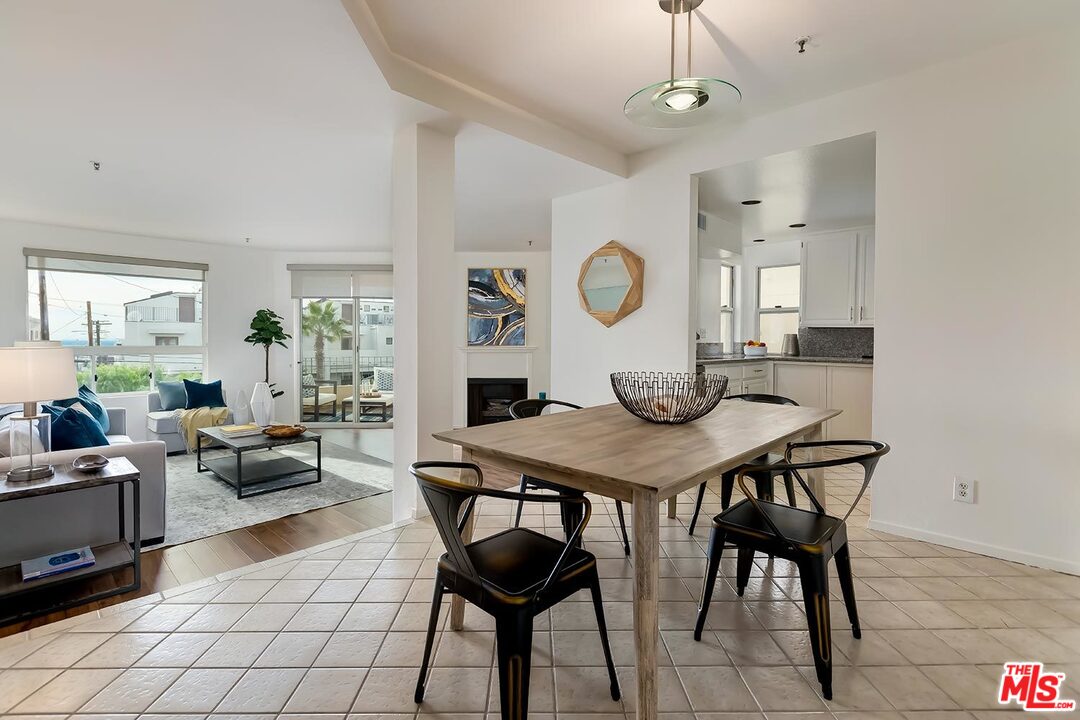 255 Main Street, Unit 207 Venice, CA 90291 - Photo 6 of 19 a living room with furniture a clock on wall and a window