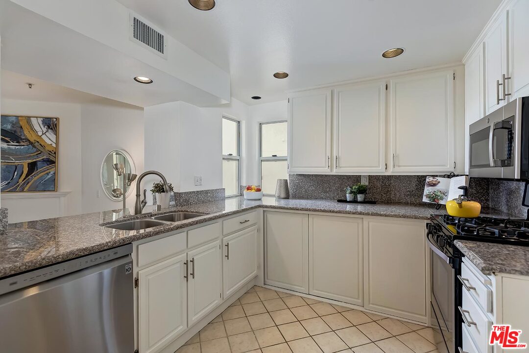 255 Main Street, Unit 207 Venice, CA 90291 - Photo 8 of 19 a kitchen with a sink stove and cabinets