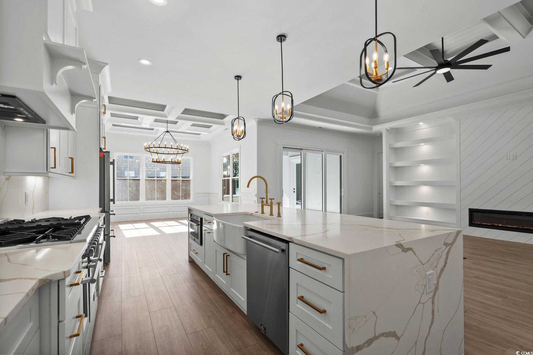 311 73rd Avenue North Myrtle Beach, SC 29572 - Photo 16 of 40 Kitchen featuring light stone countertops, white cabinetry, hanging light fixtures, dark wood-type flooring, and coffered ceiling