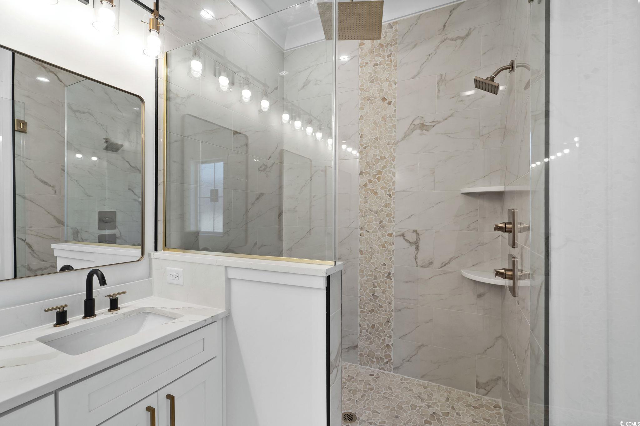 311 73rd Avenue North Myrtle Beach, SC 29572 - Photo 24 of 40 Bathroom with vanity and a marble finish shower