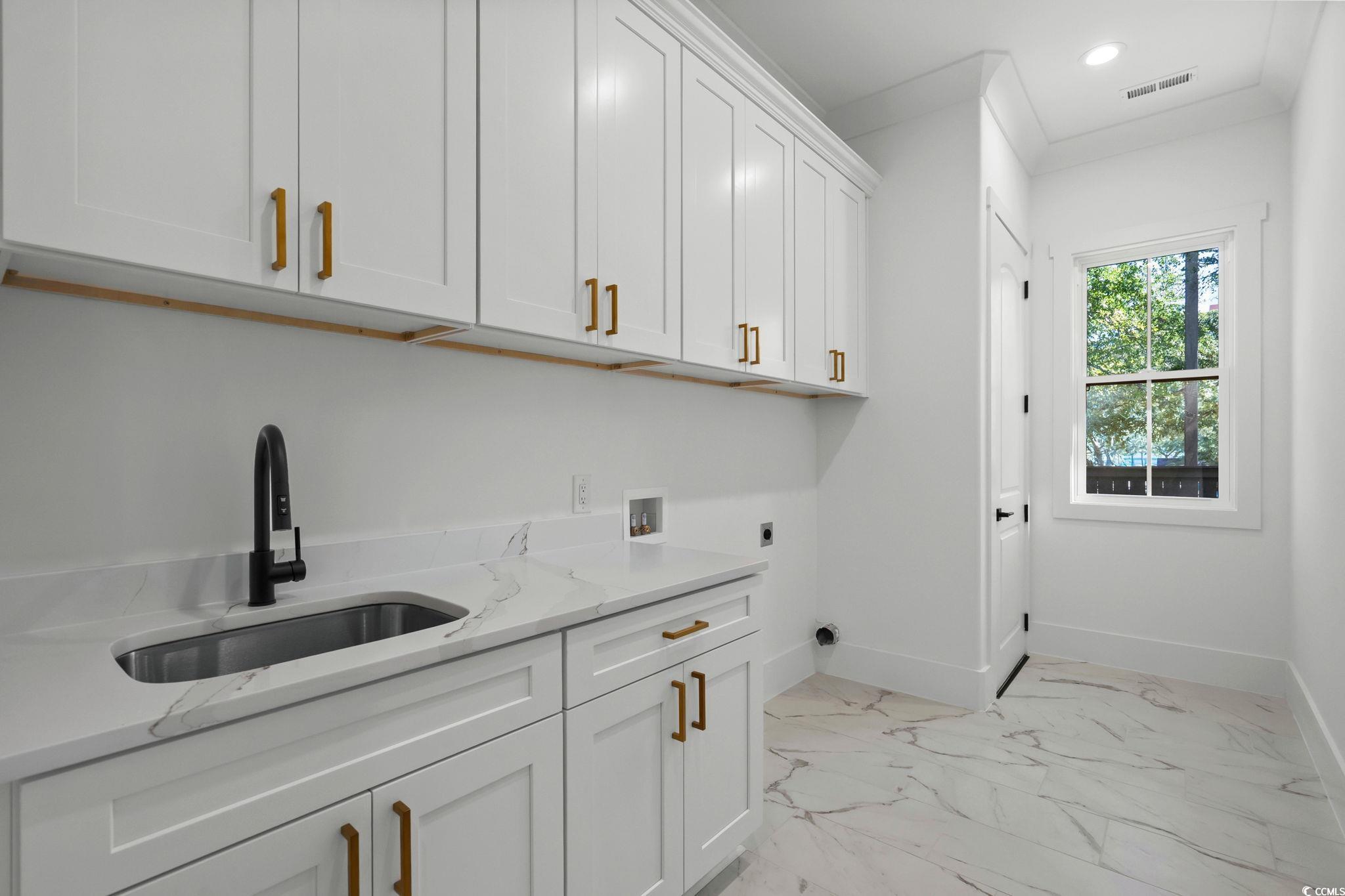 311 73rd Avenue North Myrtle Beach, SC 29572 - Photo 29 of 40 Laundry room featuring light marble finish flooring, washer hookup, cabinet space, ornamental molding, and recessed lighting