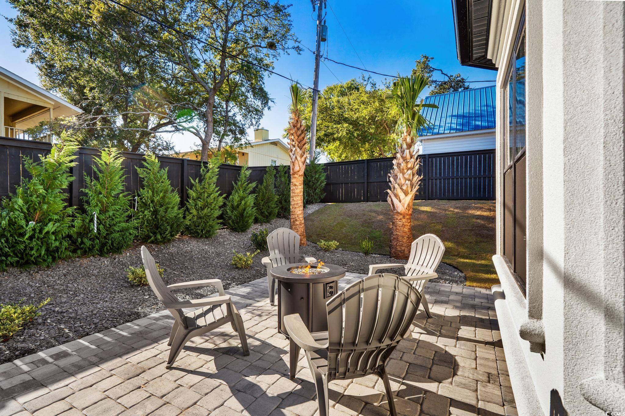 311 73rd Avenue North Myrtle Beach, SC 29572 - Photo 32 of 40 Fenced backyard with a patio area and an outdoor fire pit