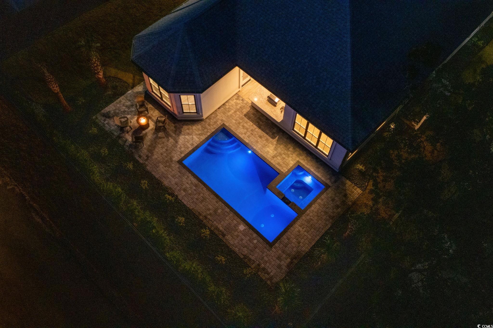 311 73rd Avenue North Myrtle Beach, SC 29572 - Photo 38 of 40 Pool at twilight with a pool with connected hot tub