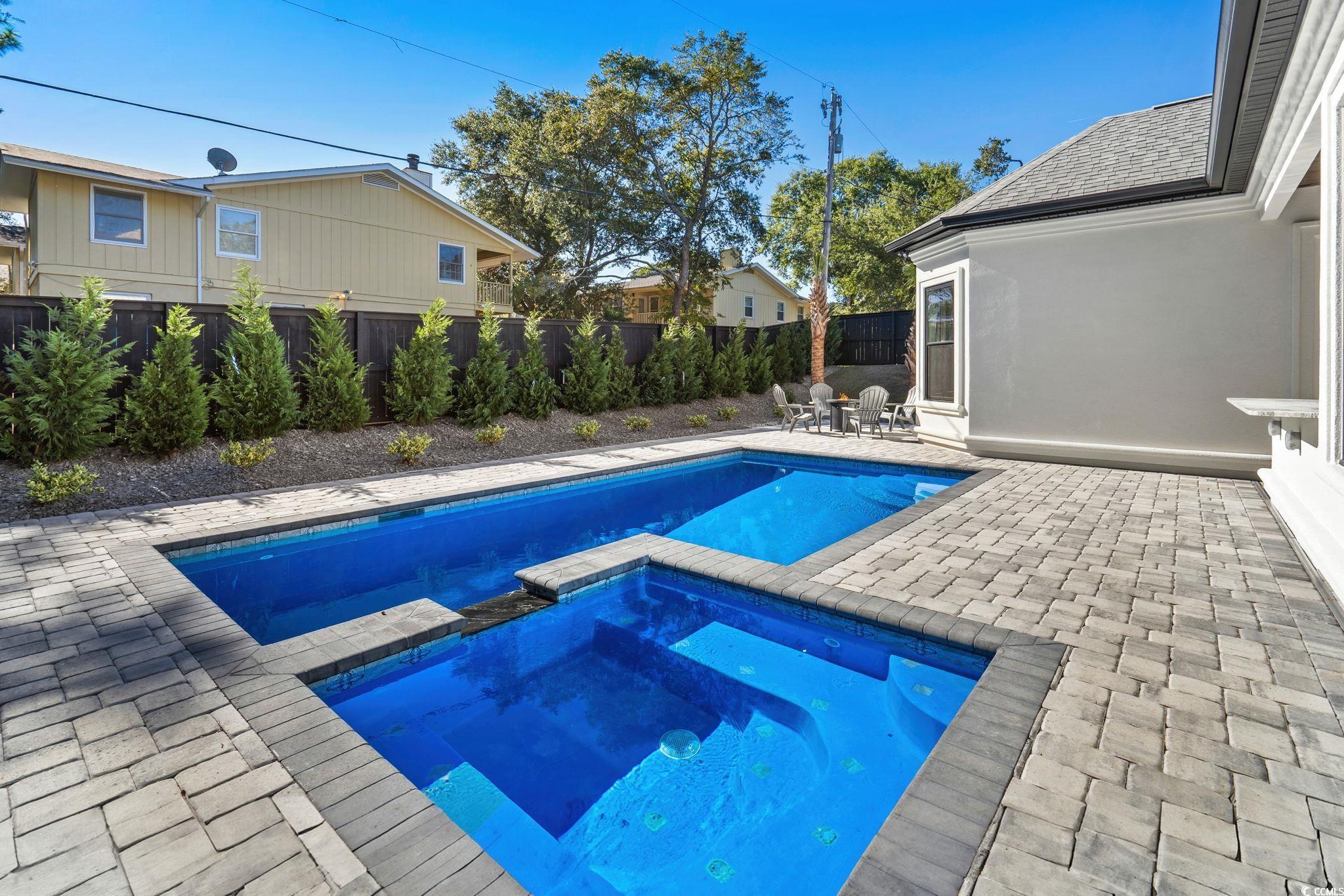 311 73rd Avenue North Myrtle Beach, SC 29572 - Photo 7 of 40 View of pool featuring a patio, a fenced backyard, and a pool with connected hot tub