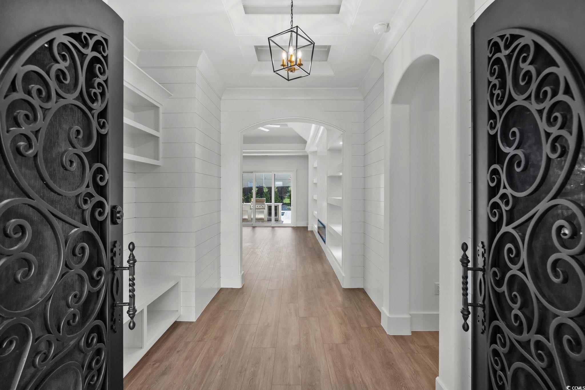 311 73rd Avenue North Myrtle Beach, SC 29572 - Photo 8 of 40 Foyer featuring arched walkways, wood finished floors, and a chandelier