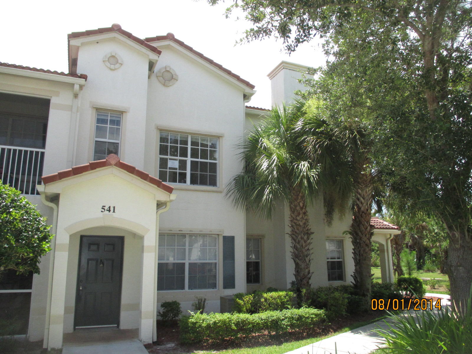 541 Southeast Prescott Place, Unit 541 Stuart, FL 34994 - Photo 1 of 20 front view of a house with a garden