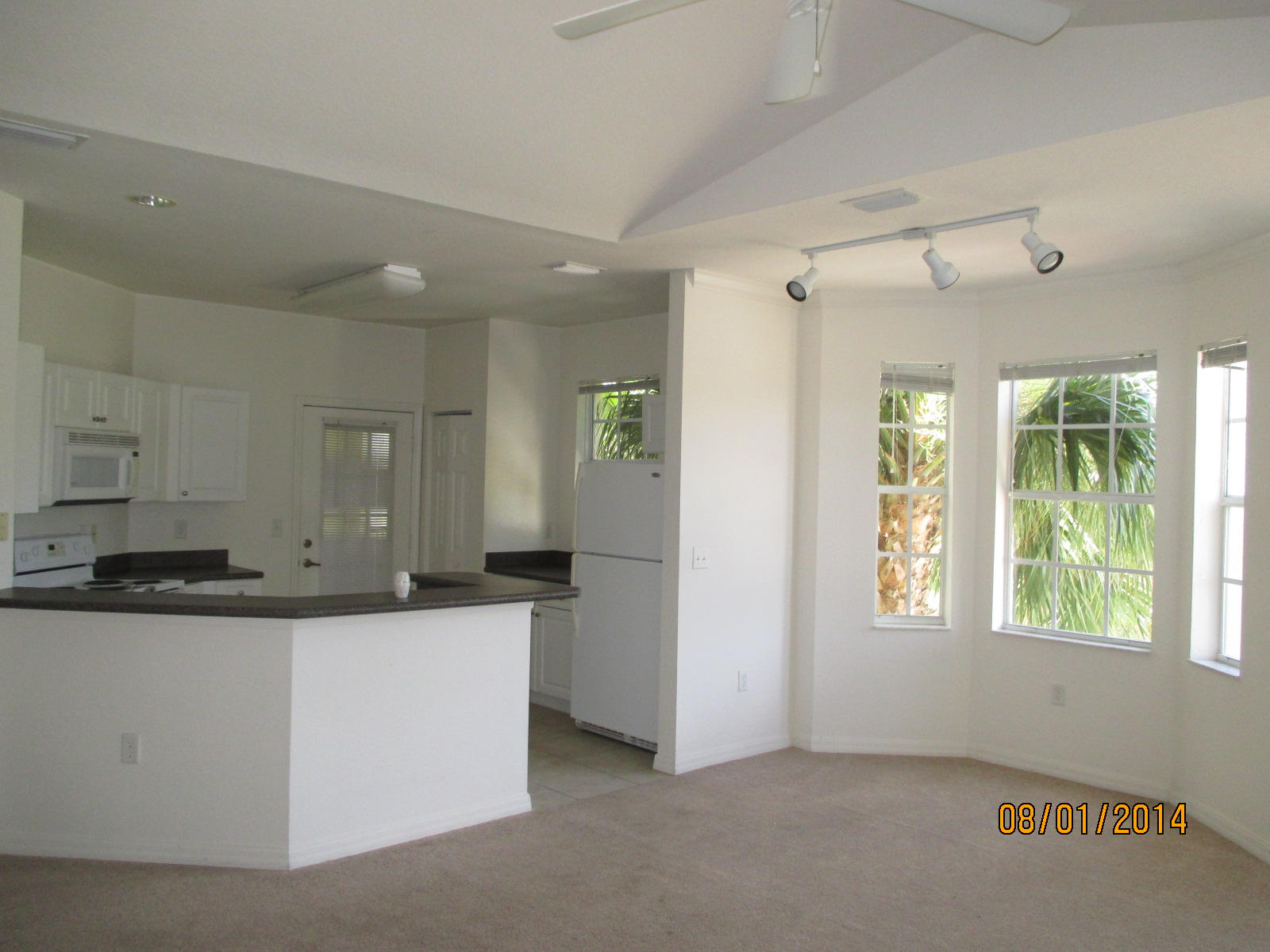 541 Southeast Prescott Place, Unit 541 Stuart, FL 34994 - Photo 7 of 20 a kitchen with stainless steel appliances granite countertop a sink and a refrigerator