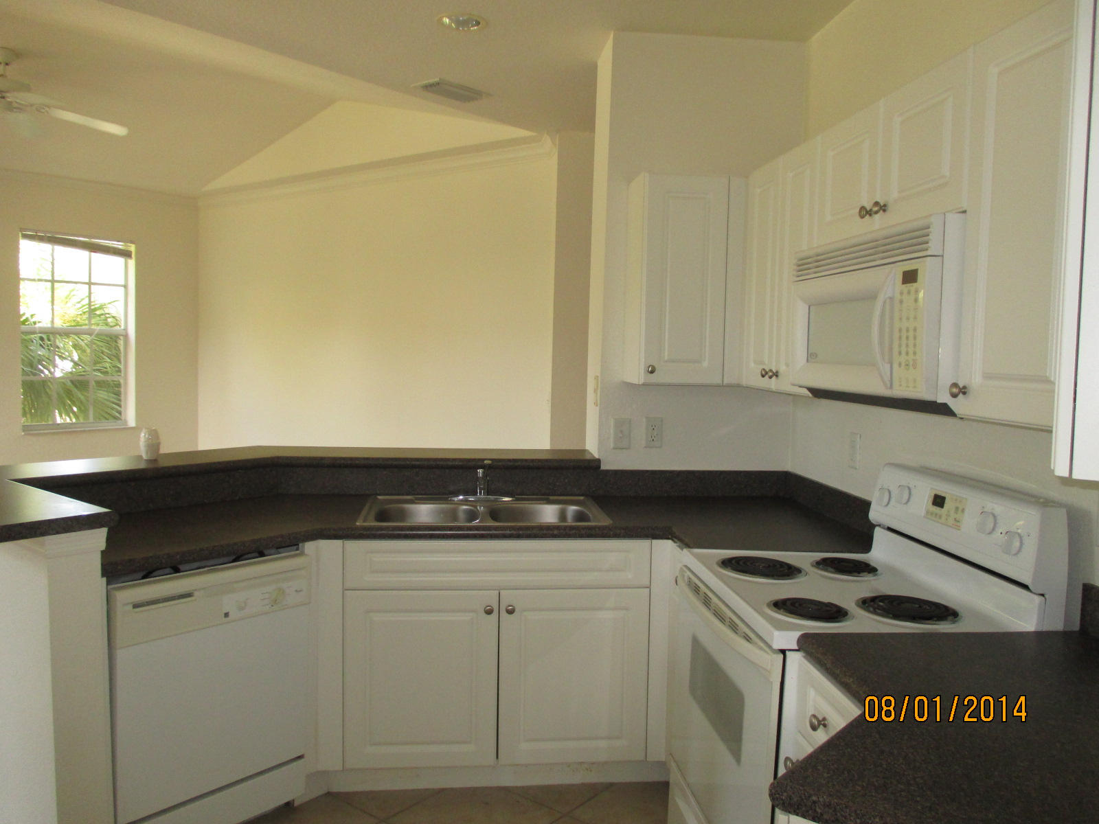 541 Southeast Prescott Place, Unit 541 Stuart, FL 34994 - Photo 9 of 20 a kitchen with granite countertop cabinets and a stove top oven