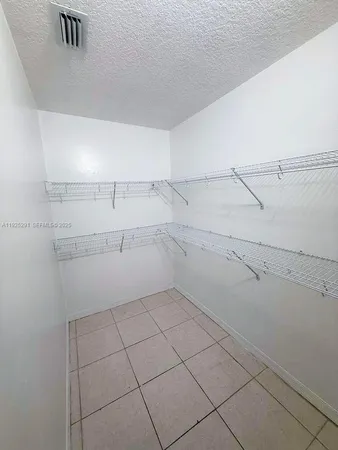 a view of a storage and utility room with racks on the wall