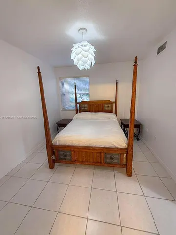 a bedroom with a bed and a table