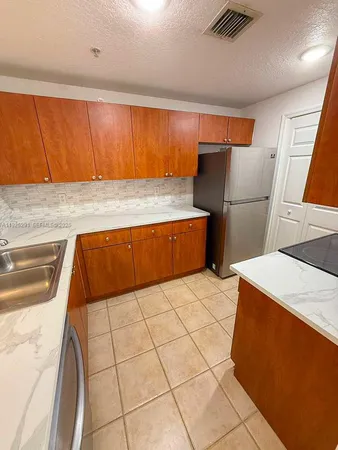a kitchen with stainless steel appliances a stove a microwave and a sink