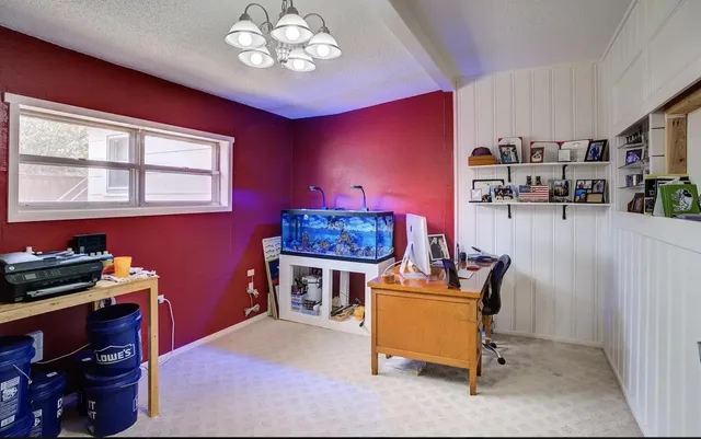 a work room with furniture and chandelier