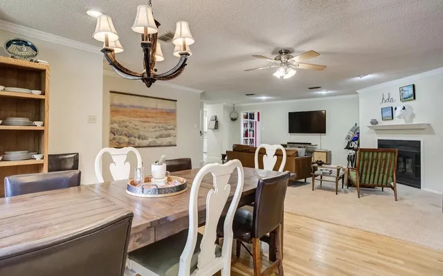 a dining room with furniture a flat screen tv and a fireplace