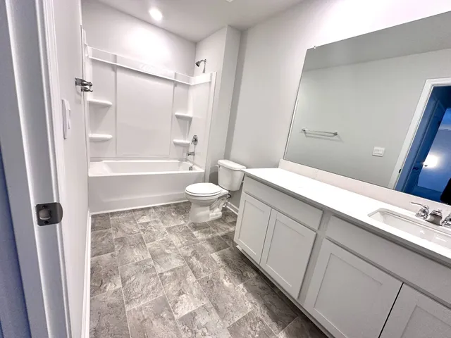 a bathroom with sink a mirror a bathtub and shower