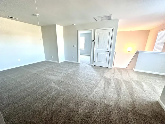 a view of an empty room and a bathroom