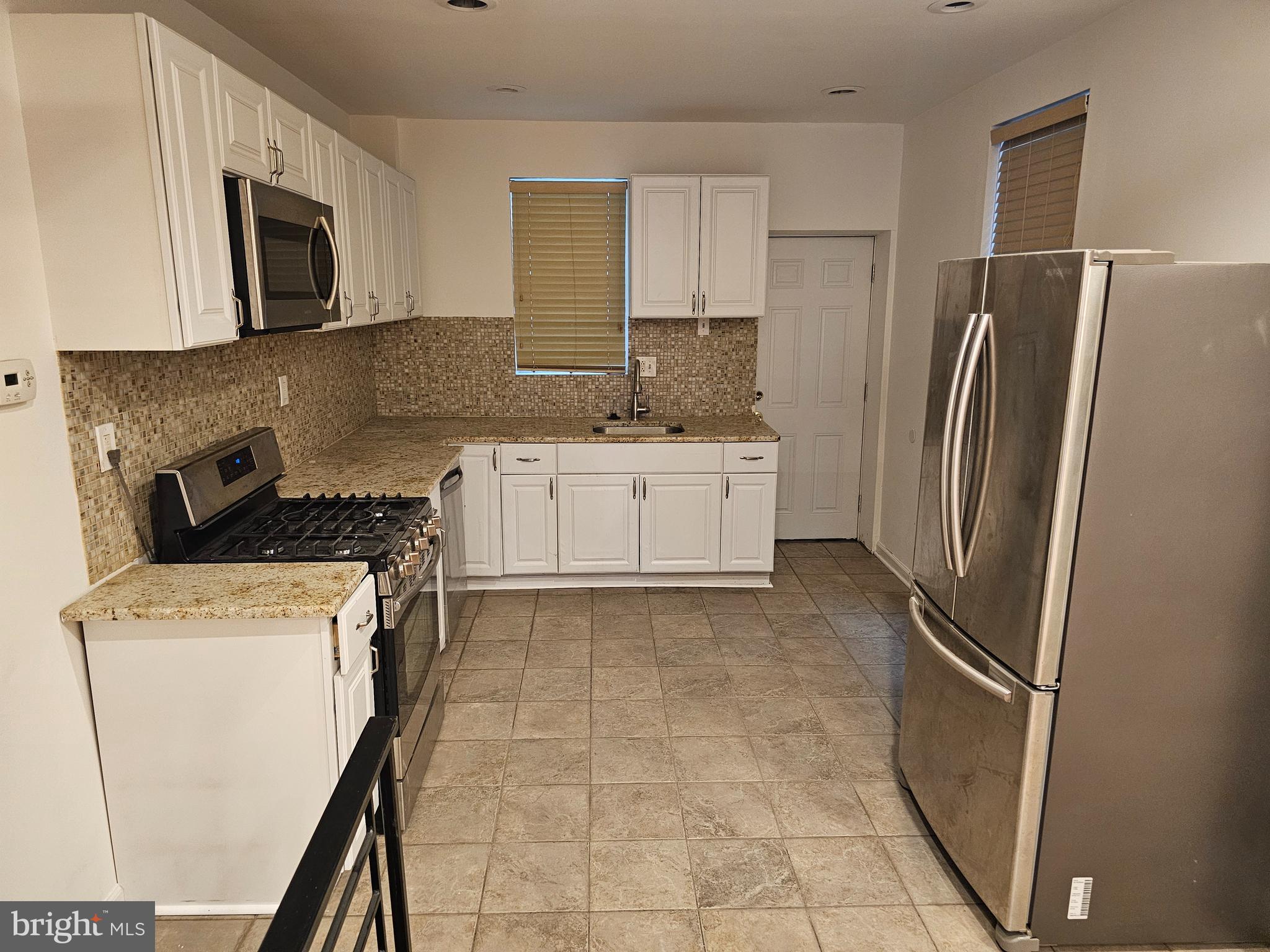 3025 Redner Street Philadelphia, PA 19121 - Photo 4 of 15 a kitchen with a refrigerator sink and microwave