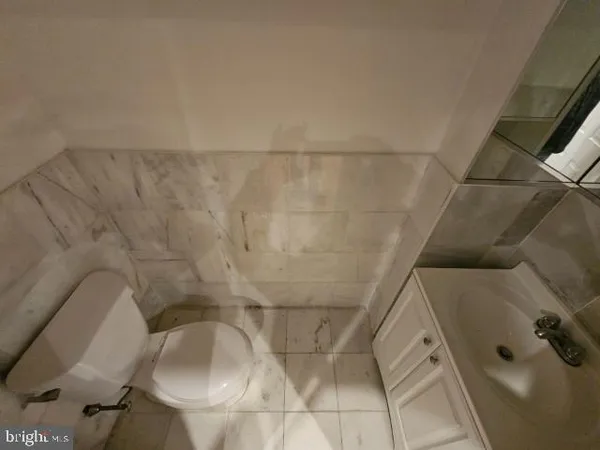 a bathroom with a toilet and a tub