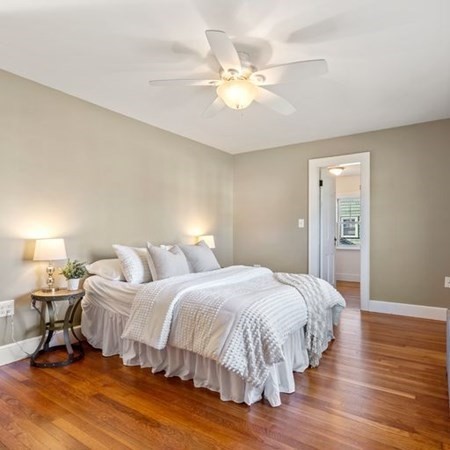35 Welgate Road Medford, MA 02155 - Photo 22 of 40 a bedroom with a bed and a chandelier