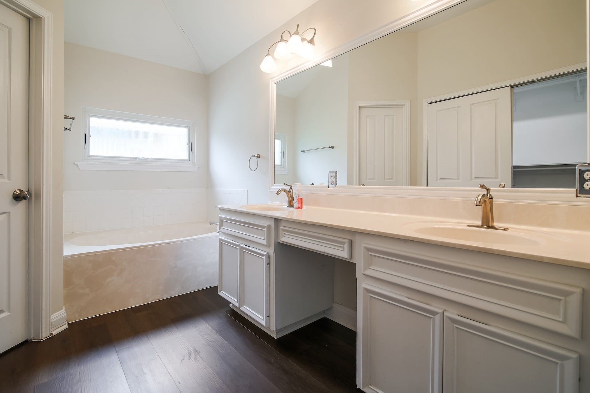 1713 Apache Trail Round Rock, TX 78665 - Photo 18 of 39 a sink with white cabinets and wooden floor