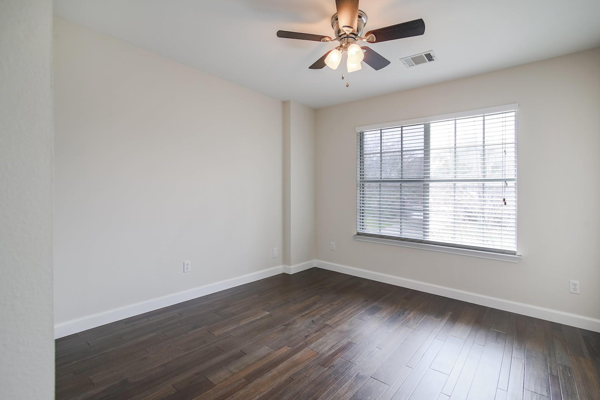 1713 Apache Trail Round Rock, TX 78665 - Photo 20 of 39 wooden floor in an empty room with a window