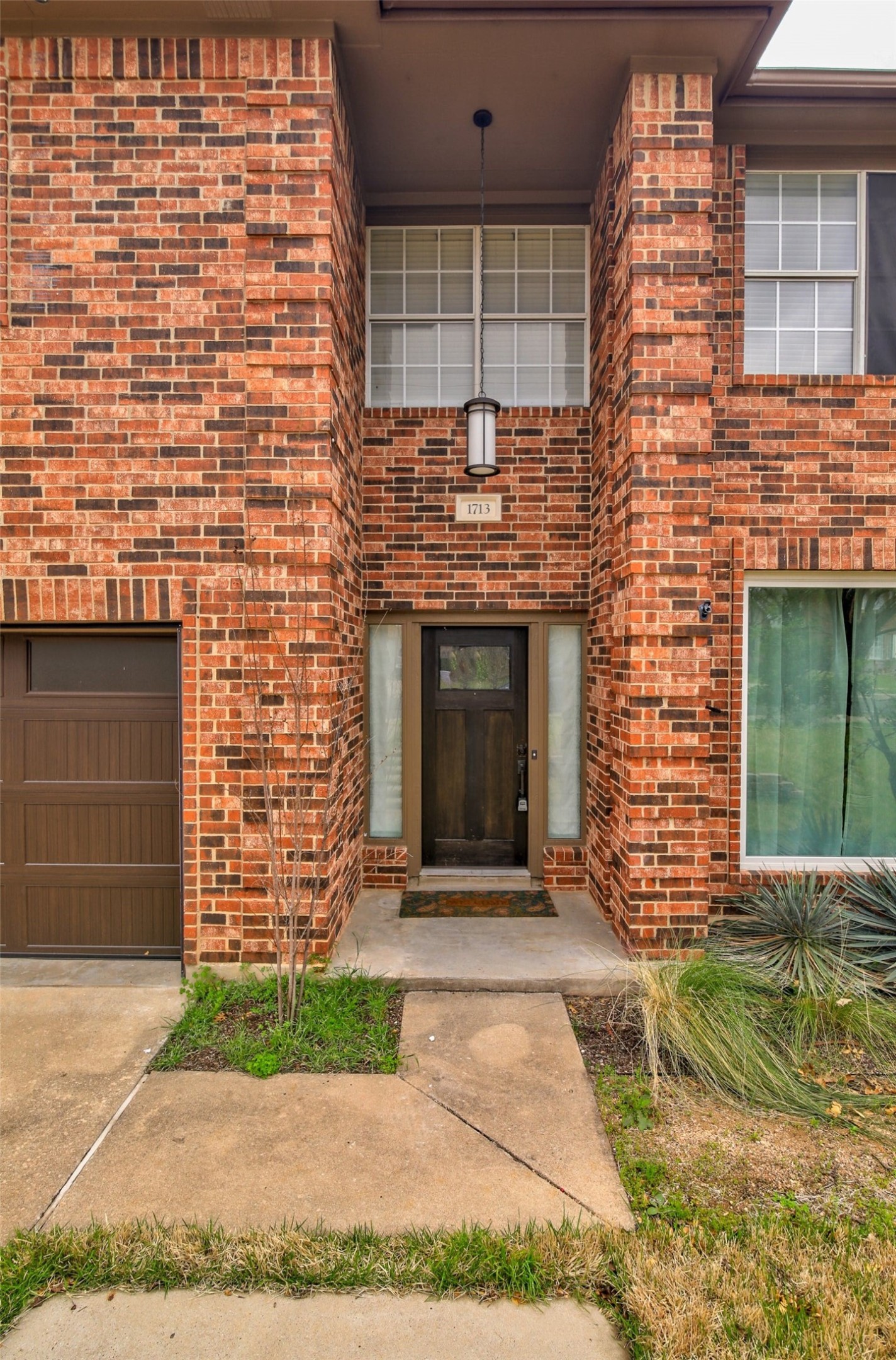 1713 Apache Trail Round Rock, TX 78665 - Photo 3 of 39 a front view of a house with a garden