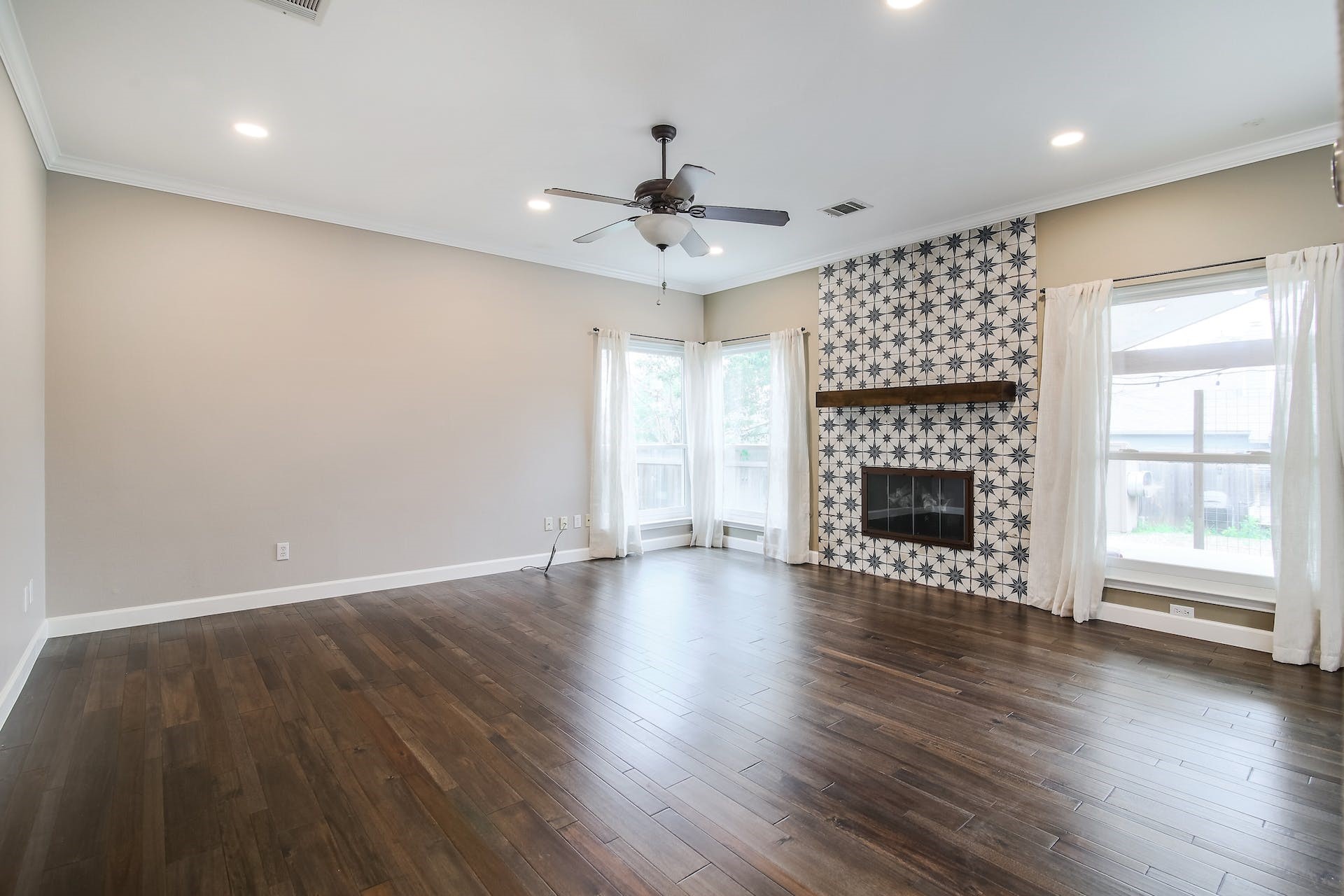 1713 Apache Trail Round Rock, TX 78665 - Photo 4 of 39 an empty room with wooden floor fireplace and windows