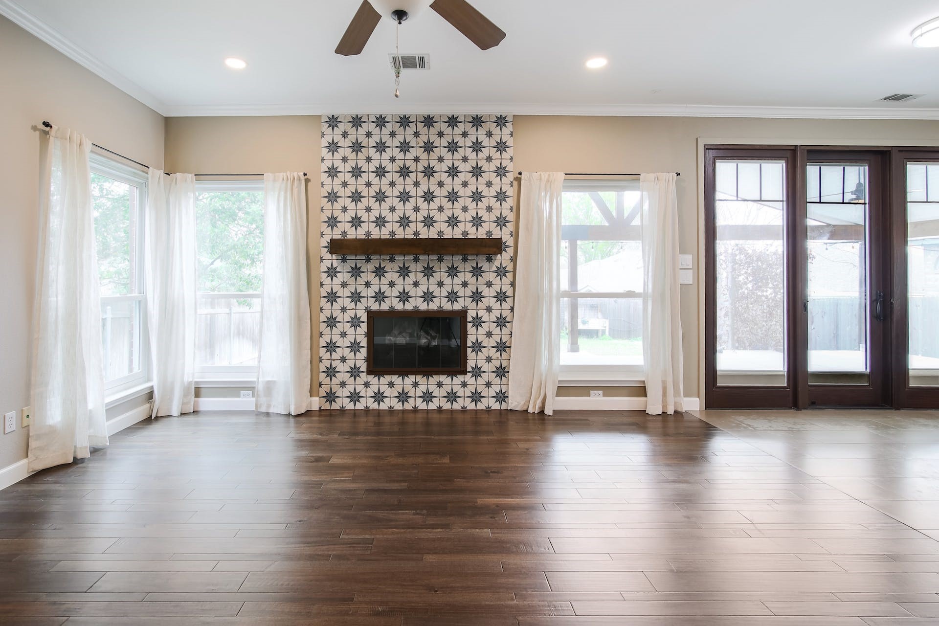 1713 Apache Trail Round Rock, TX 78665 - Photo 5 of 39 an empty room with wooden floor fireplace and windows
