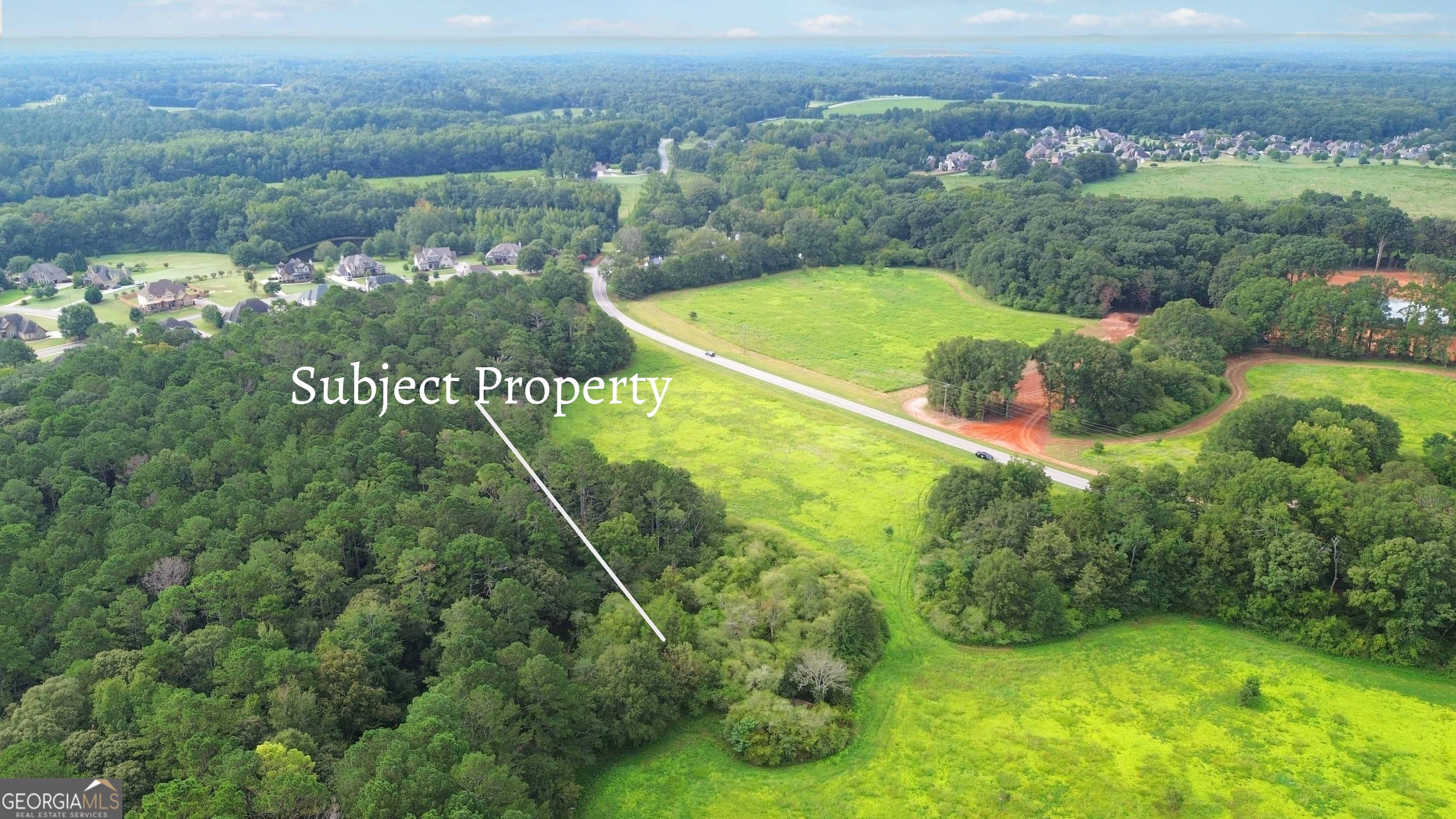 Lot 10 Sikes Road Statham, GA 30666 - Photo 8 of 10 an aerial view of a residential houses with outdoor space and trees all around