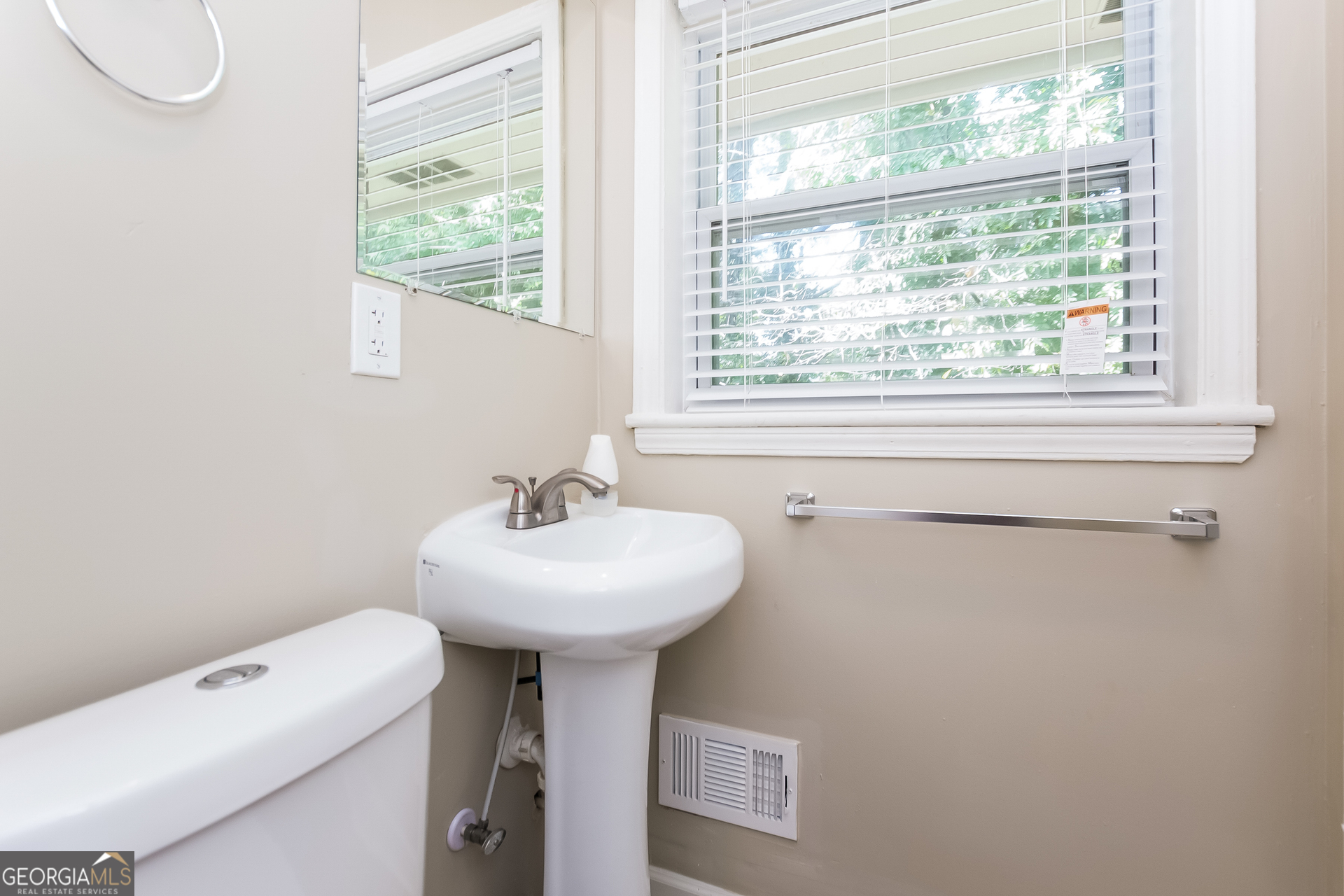 2309 Omaha Road Southwest Atlanta, GA 30331 - Photo 14 of 15 a bathroom with a sink a toilet and a window