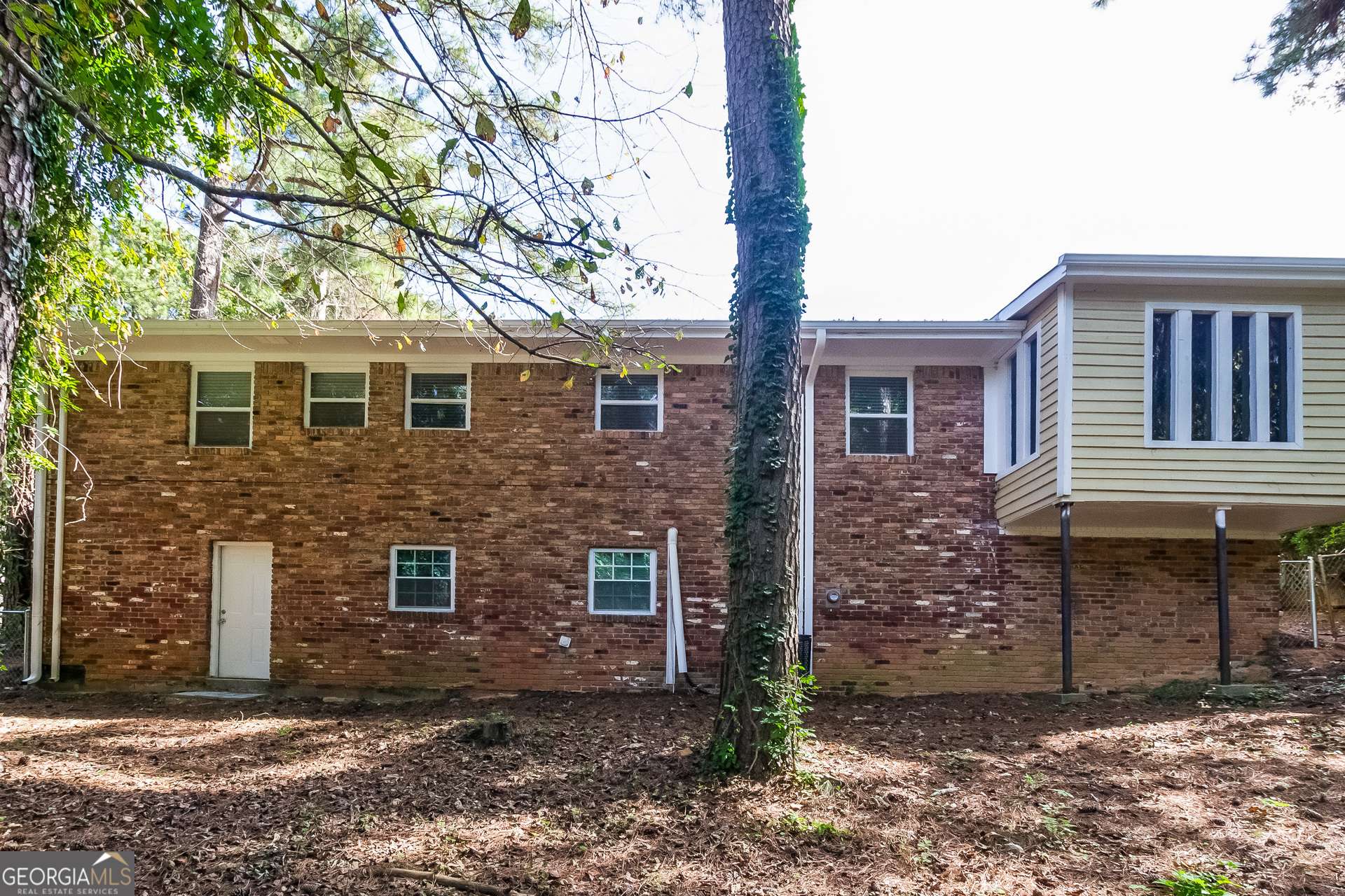 2309 Omaha Road Southwest Atlanta, GA 30331 - Photo 15 of 15 a brick house that has a small yard and large trees