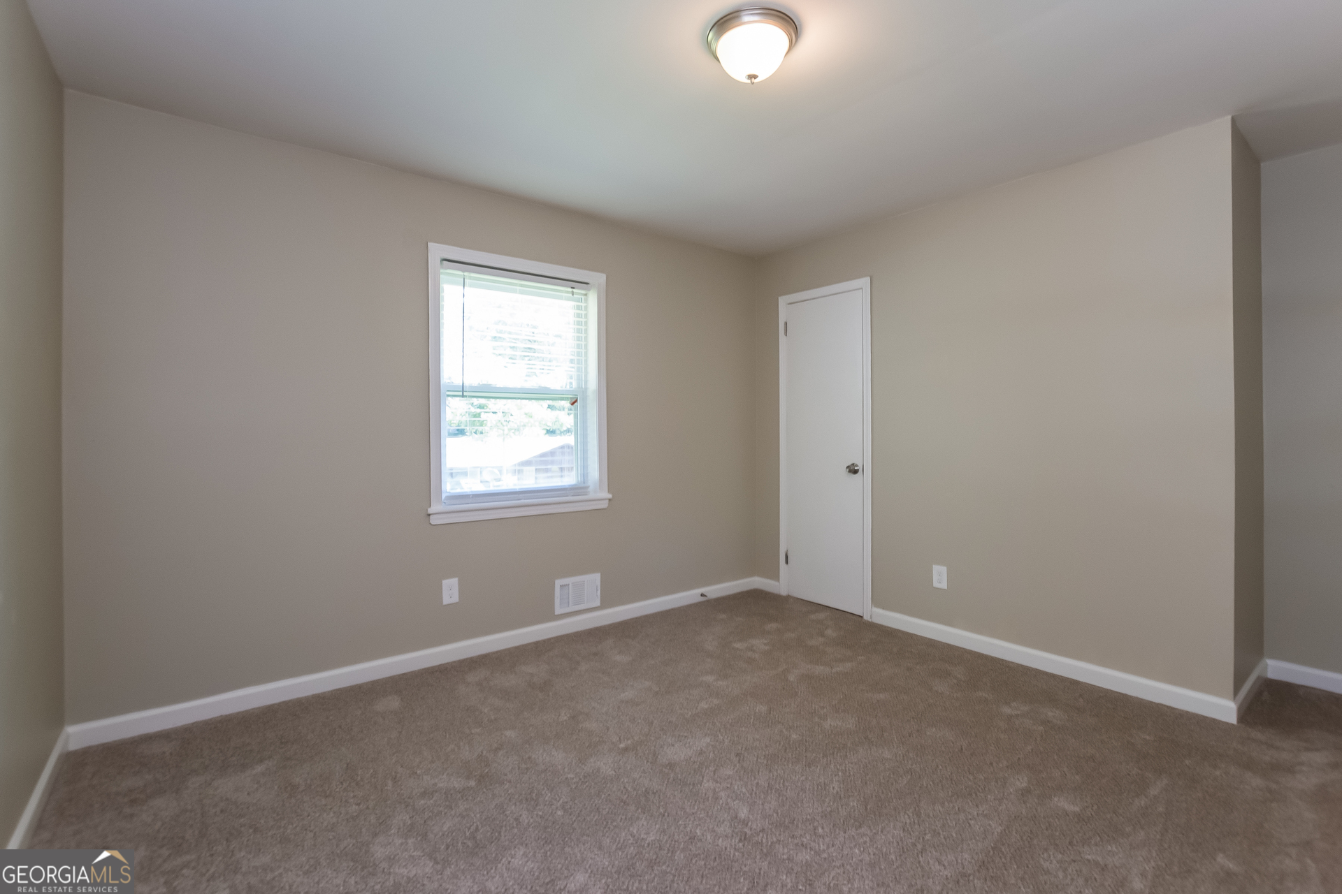 2309 Omaha Road Southwest Atlanta, GA 30331 - Photo 7 of 15 an empty room with windows