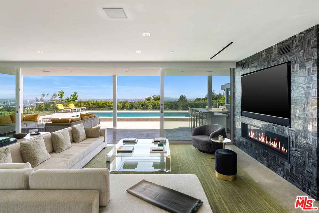 1476 Carla Ridge Beverly Hills, CA 90210 - Photo 12 of 27 a living room with furniture and a flat screen tv