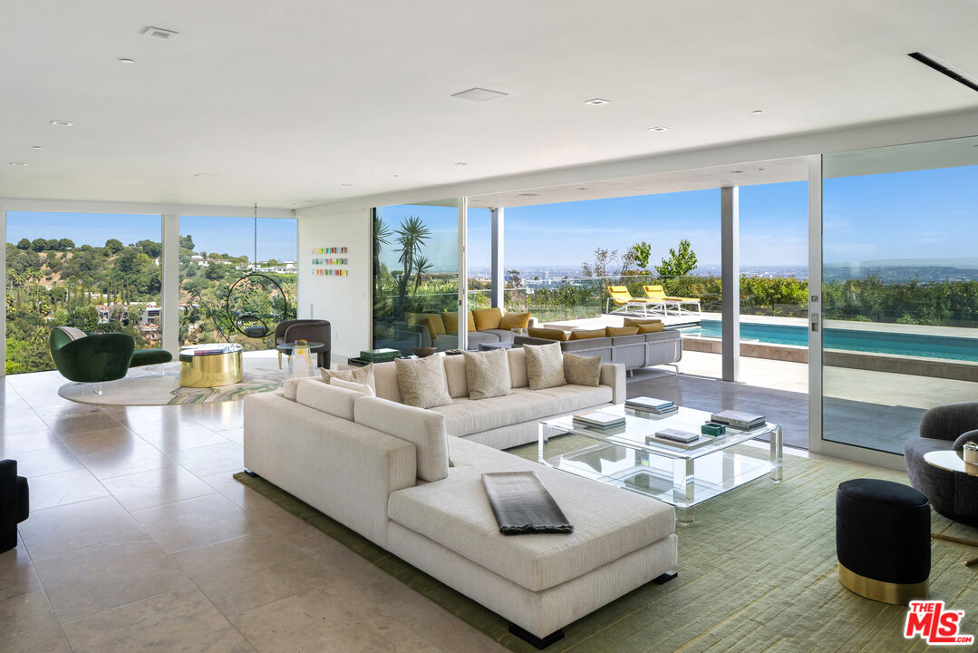 1476 Carla Ridge Beverly Hills, CA 90210 - Photo 13 of 27 a living room with furniture and a large window