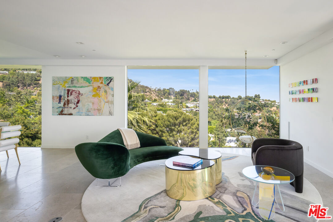 1476 Carla Ridge Beverly Hills, CA 90210 - Photo 14 of 27 a living room with furniture and a large window