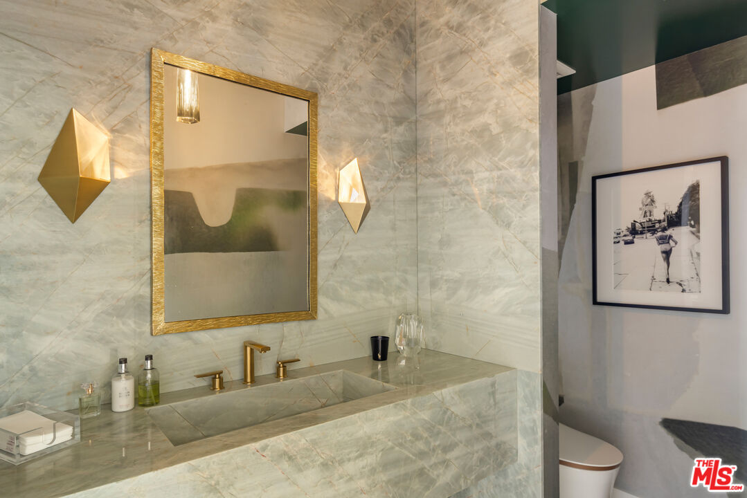 1476 Carla Ridge Beverly Hills, CA 90210 - Photo 19 of 27 a bathroom with a toilet sink and mirror