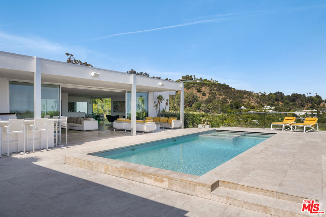1476 Carla Ridge Beverly Hills, CA 90210 - Photo 20 of 27 a view of a patio with swimming pool table and chairs