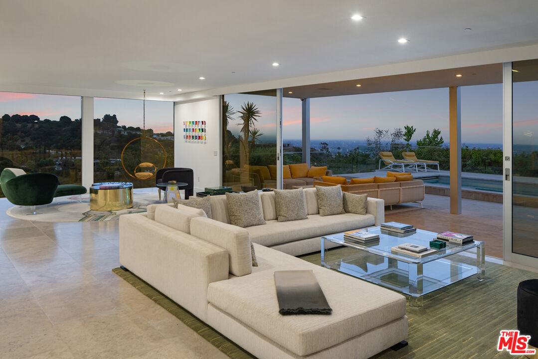 1476 Carla Ridge Beverly Hills, CA 90210 - Photo 2 of 27 a living room with furniture and a large window