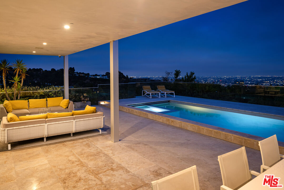 1476 Carla Ridge Beverly Hills, CA 90210 - Photo 25 of 27 a swimming pool with outdoor seating and yard