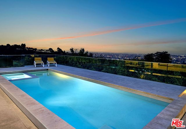 a view of a swimming pool with an outdoor seating
