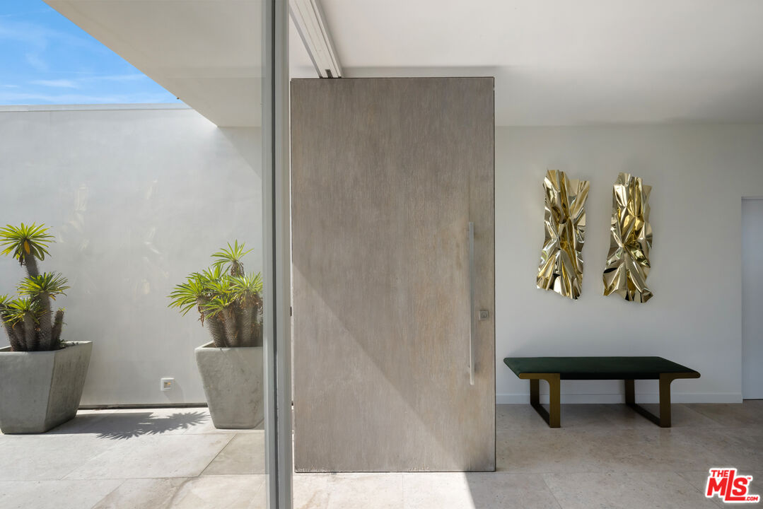 1476 Carla Ridge Beverly Hills, CA 90210 - Photo 10 of 27 a view of a entryway with flower plants